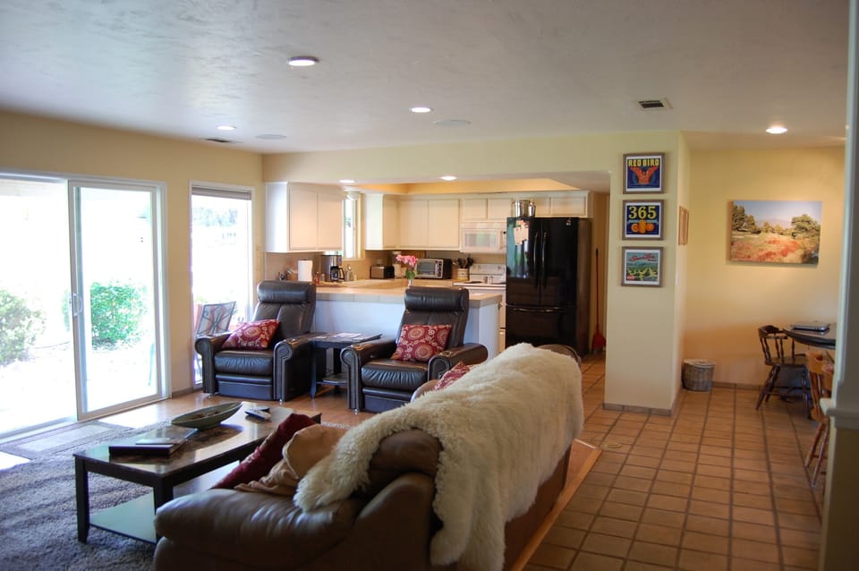 Family room with two motorized leather chairs and our fully equipped Kitchen