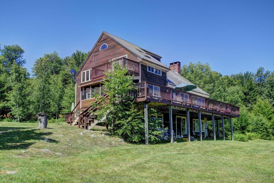 Large back deck overlooks 5 landscaped acres and rolling hills 