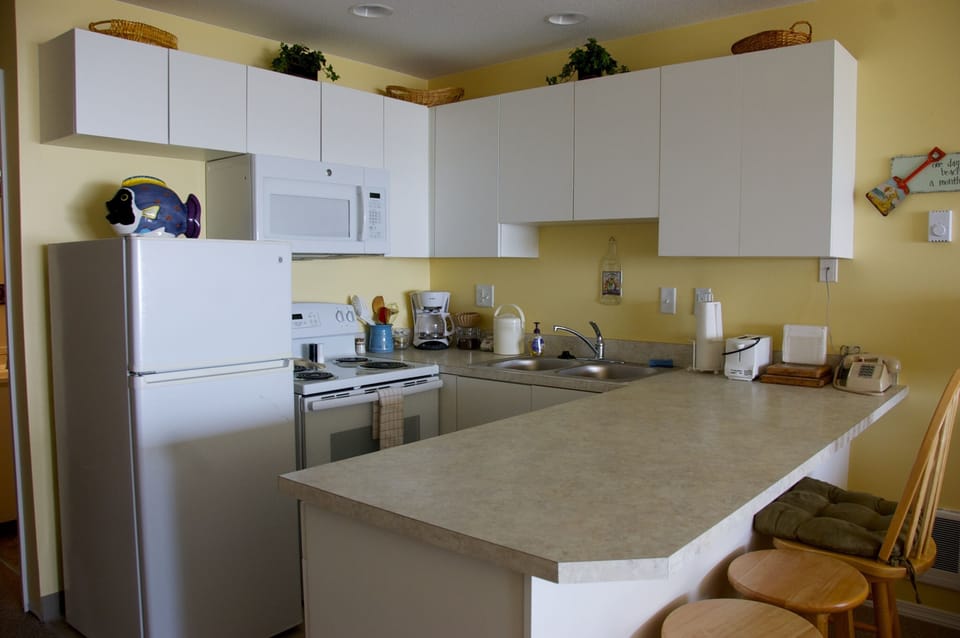 Brand new kitchen with new stove, refrigerator, and microwave.