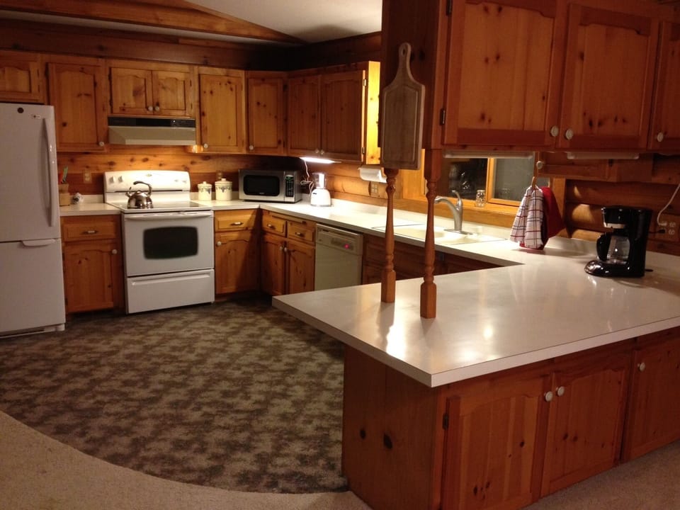 Full Kitchen with bar seating open to the dining room and living area.