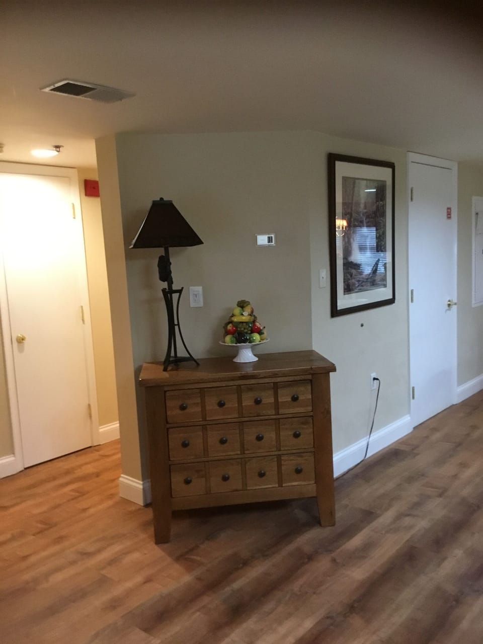 Left of this cabinet, is hallway to both bedrooms, one on each end.