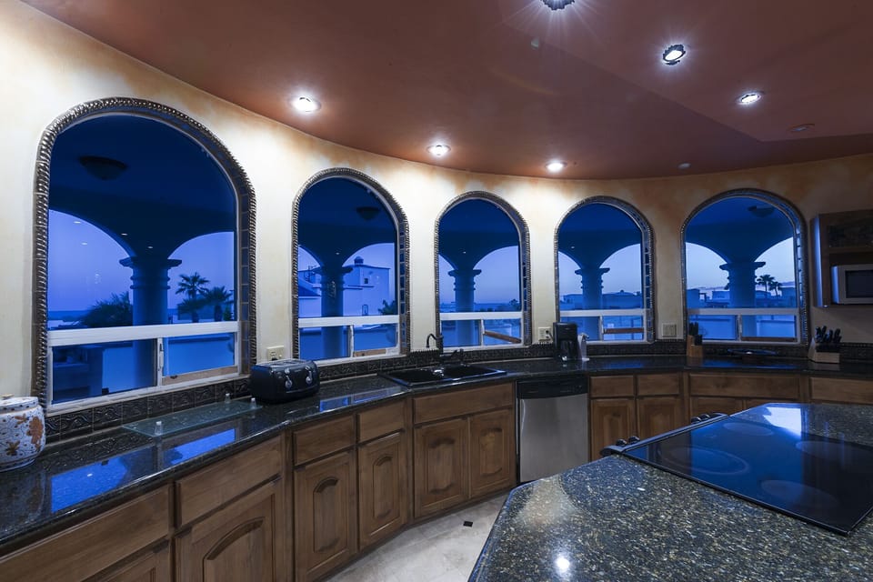 Twilight time looking out kitchen arched windows