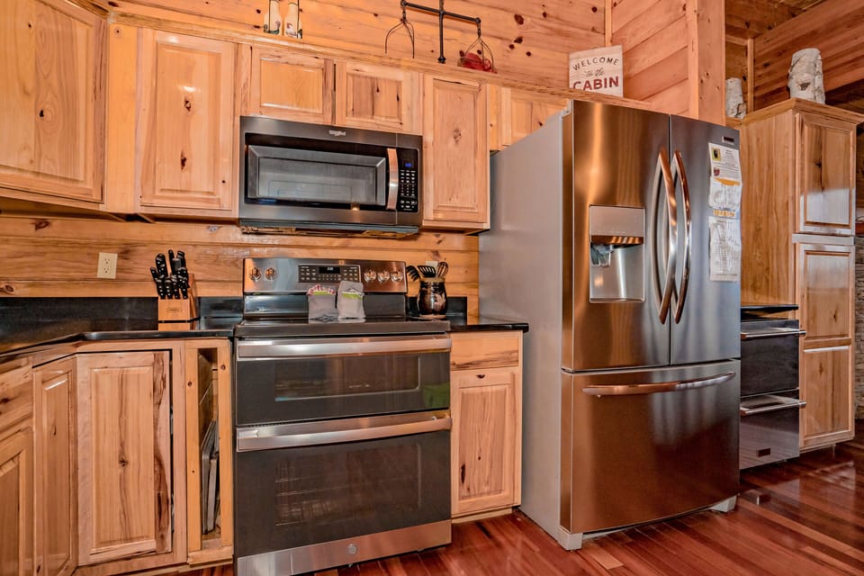 Double oven, large refrigerator and smaller drawer refrigerator.