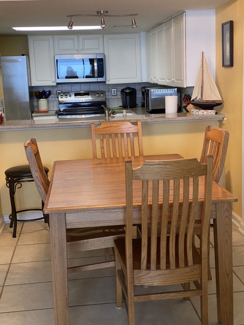 Dining room table with 4 chairs and 3 stools