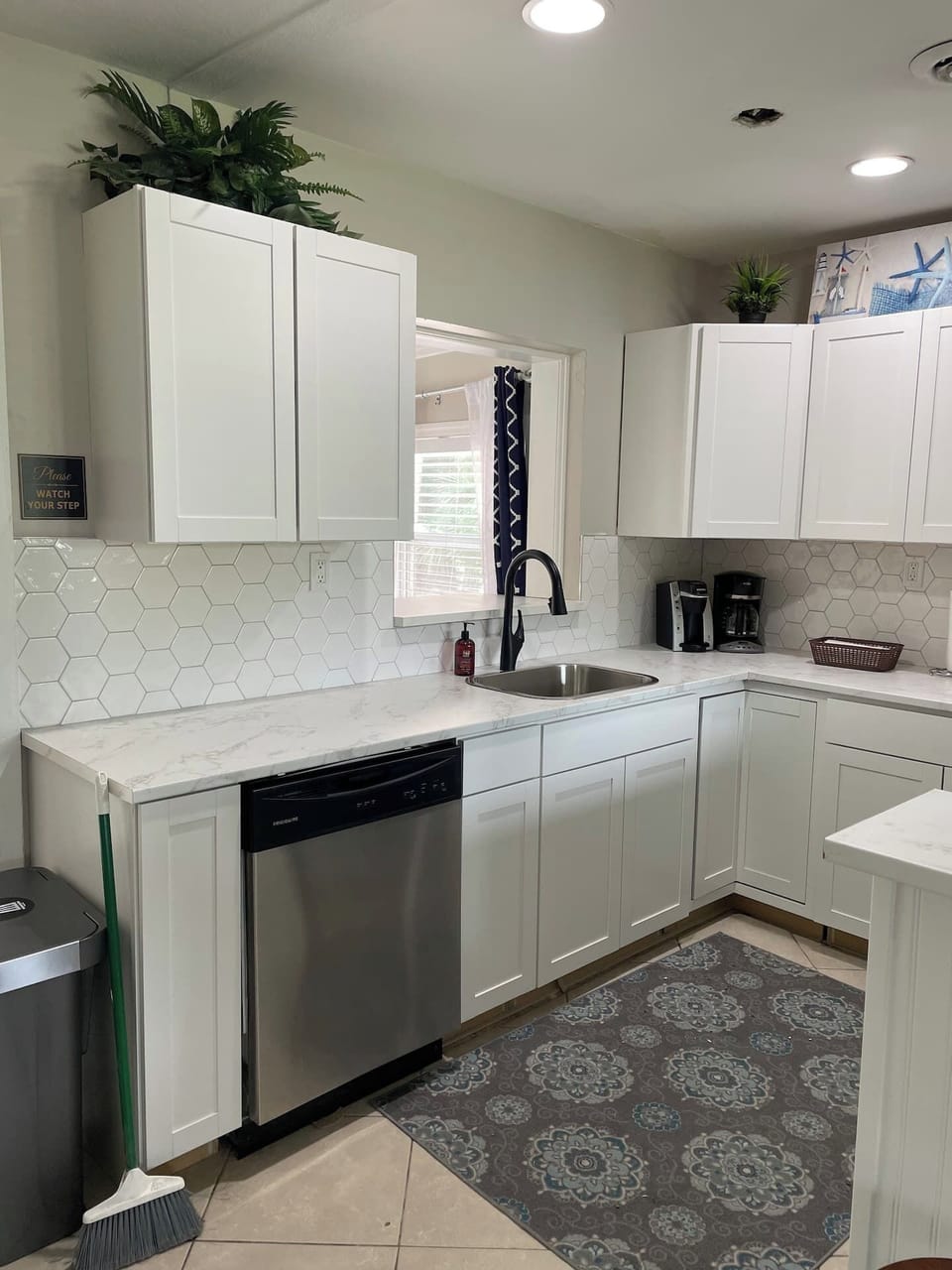 Brand new cabinets, countertop and stainless steel appliances adorn light & airy kitchen