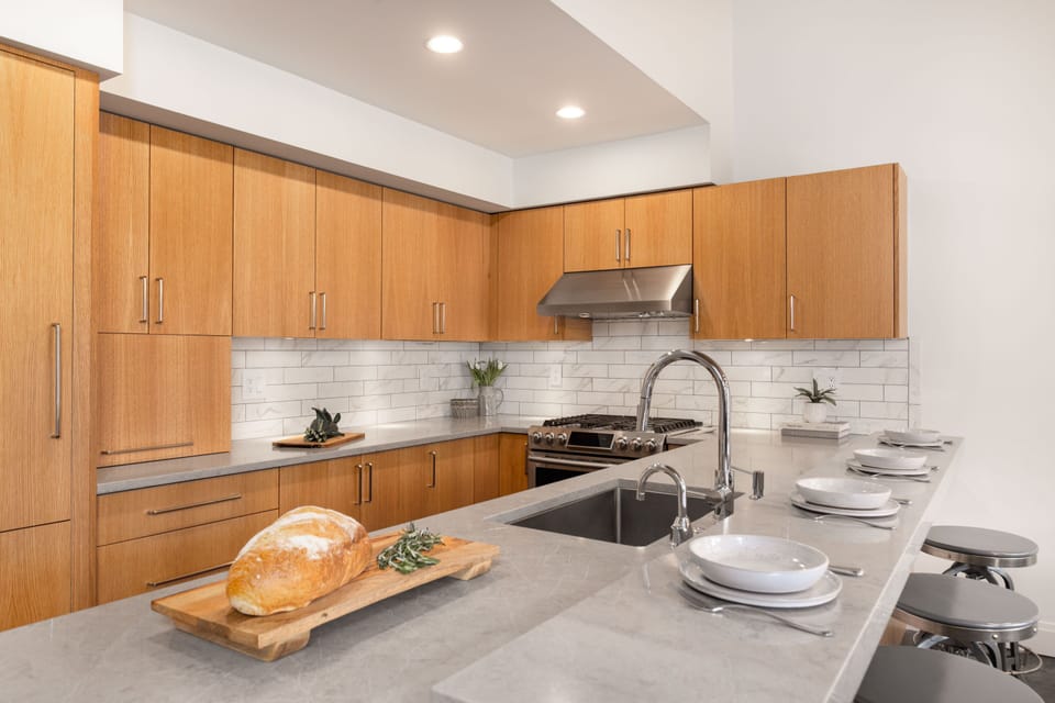 Toaster, coffee maker and blender in counter top appliance cabinet