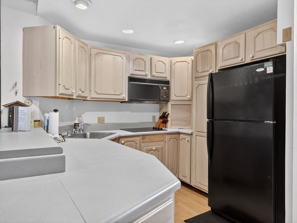 Prepare your favorite meals in this well-equipped kitchen featuring full-size appliances, ample counter space, and plenty of storage for all your culinary needs.