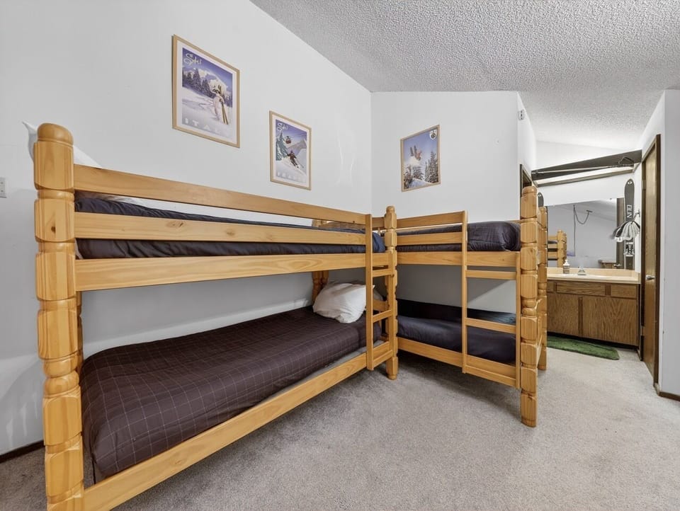 Your family will love this cozy bunk room with sturdy wooden beds and convenient sink area for getting ready.