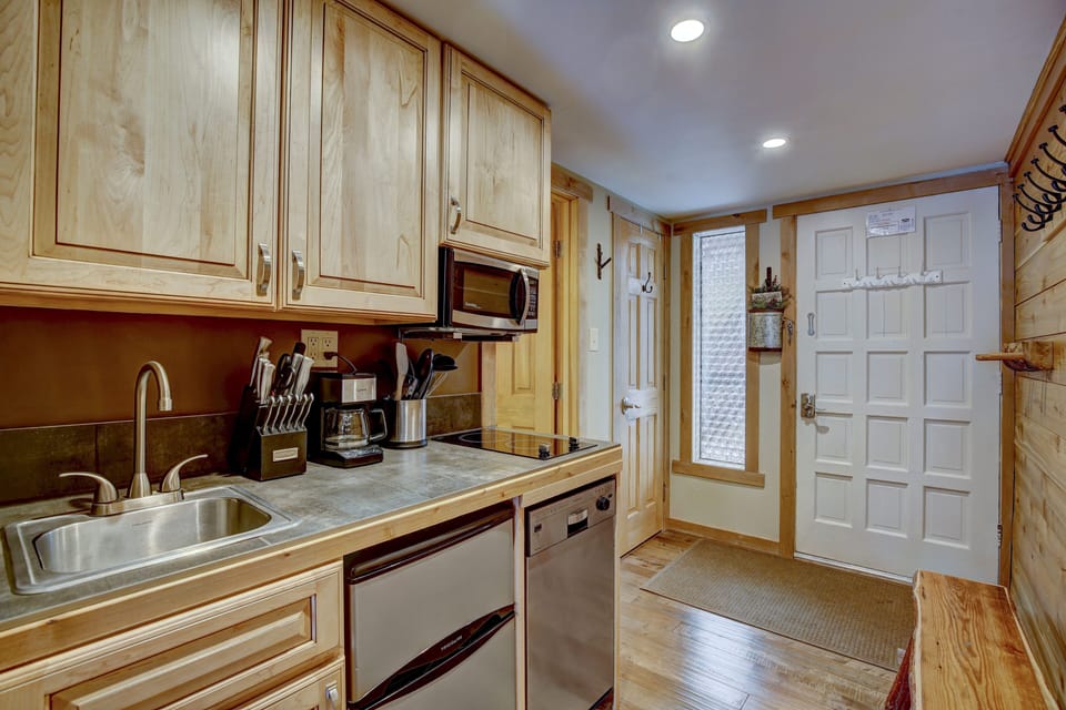 Kitchenette with two burner stovetop, microwave, dishwasher, and mini fridge