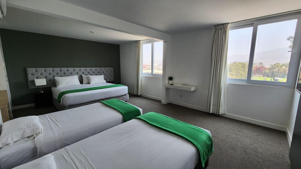 Quadruple Room | Minibar, in-room safe, desk, iron/ironing board
