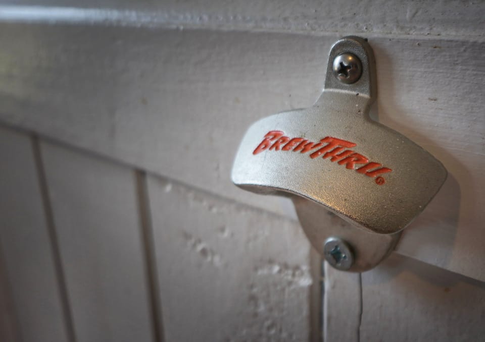 Wall mounted "Brew Thru" bottle opener