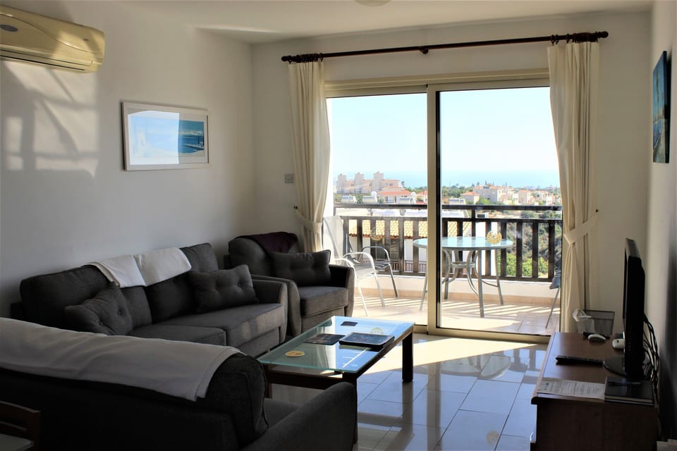 Lounge with patio doors opening on to the terrace with view s of the Med.