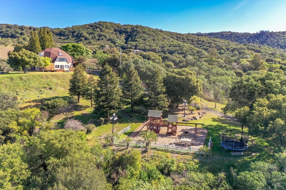 Drone photo of property showing the house and playground