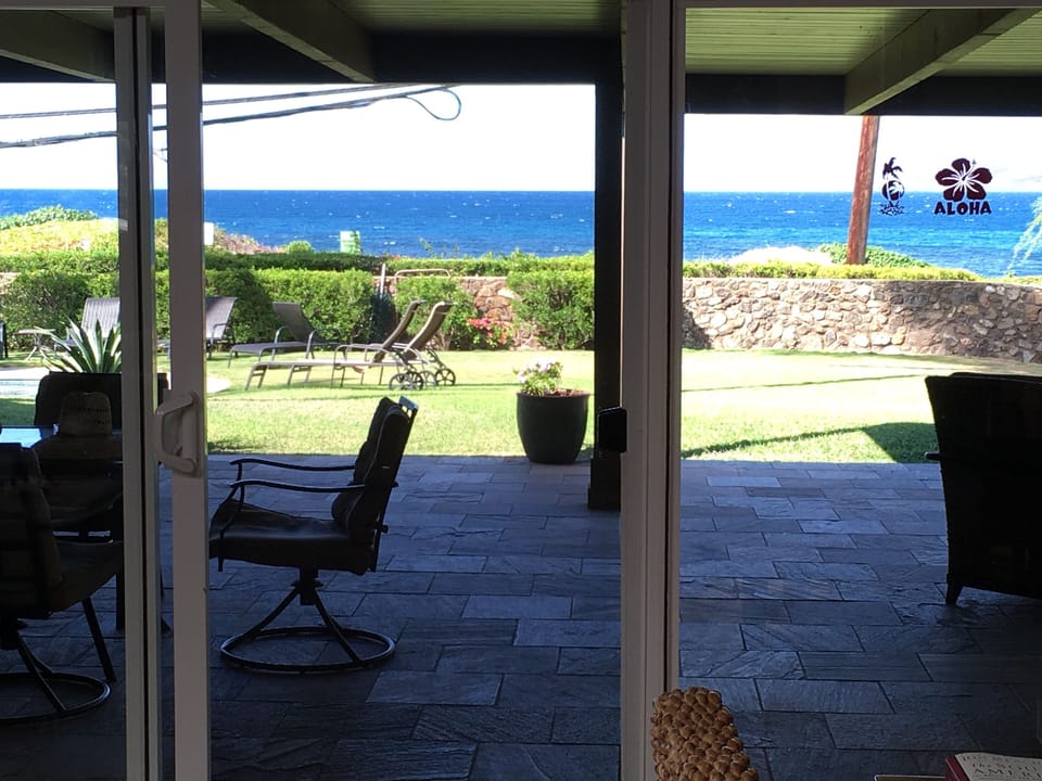 The view standing in our living room, our lanai, lawn, pool, and ocean view.