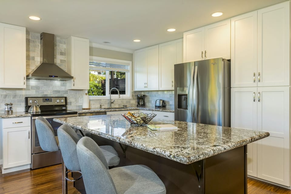 Kitchen with granite island and stainless appliances
