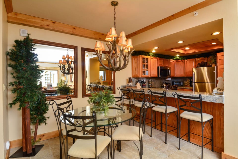 Dining area near kitchen, seating for 4 at table, plus 4 at breakfast bar.