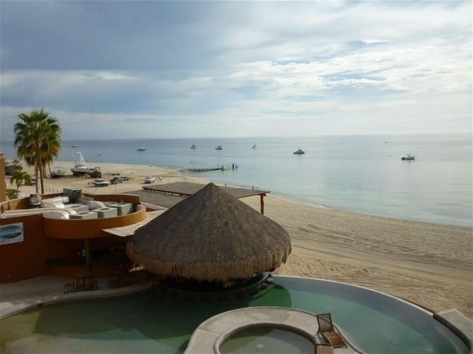 View from our balcony of the swim up bar, beach, and boat dock