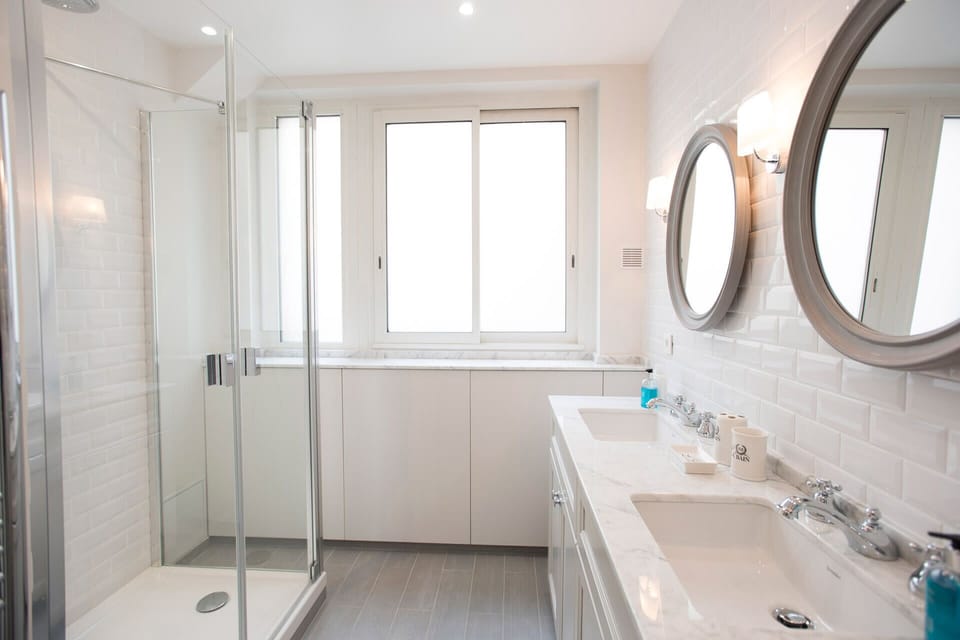 Bathroom 1 has a large shower and double sink.