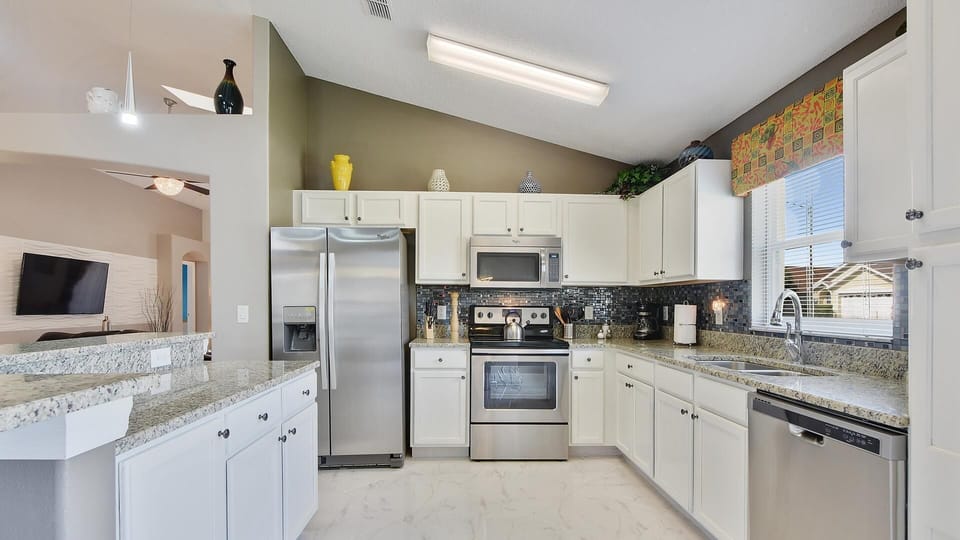 Brand new kitchen with stainless steel appliances and granit counter top