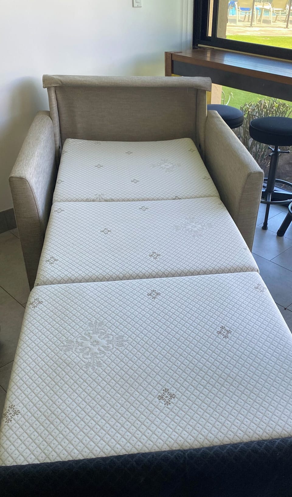 Twin sleeper chair in living room. Bedding provided.
