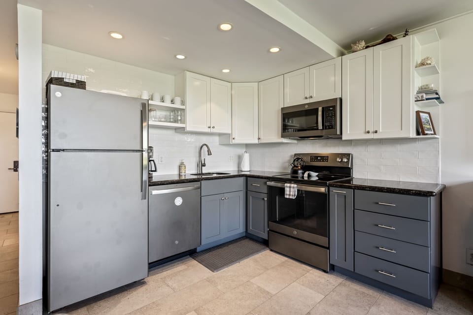The kitchen is equipped with a Vitamix, coffee grinder, coffee maker and more.
