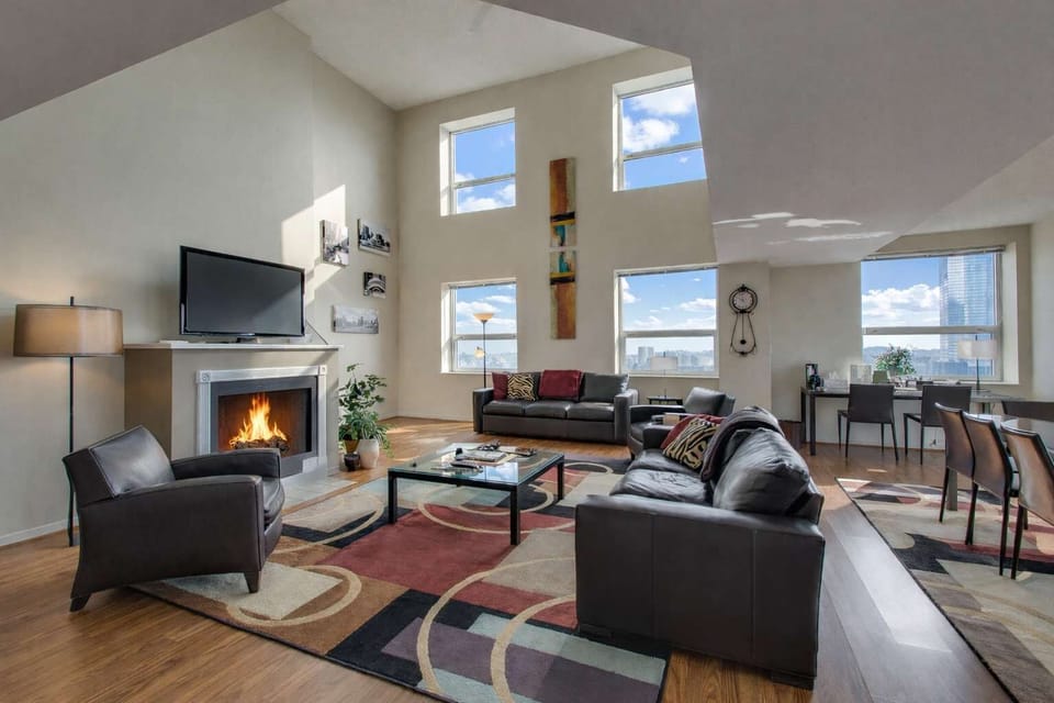 Two-story living room with a gas fireplace and a queen sleeper