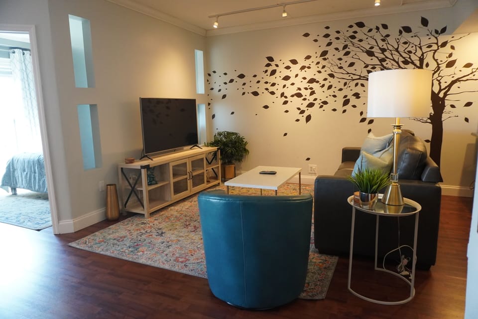 Spacious living room with new furniture and LED Smart TV.