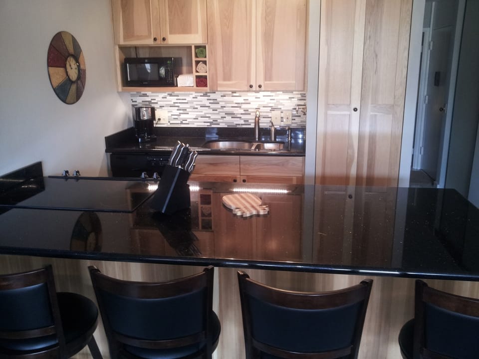 Massive Oversized Black Granite Counters and a  Stacked in unit Laundry Center.