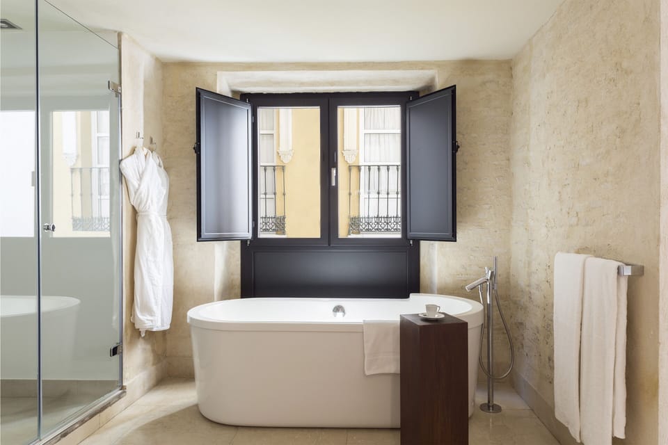 Junior Suite Views | Bathroom | Designer toiletries, hair dryer, bathrobes, towels
