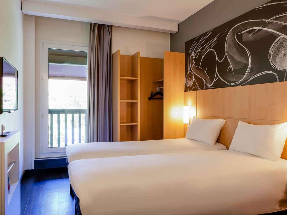 Premium bedding, desk, laptop workspace, blackout drapes