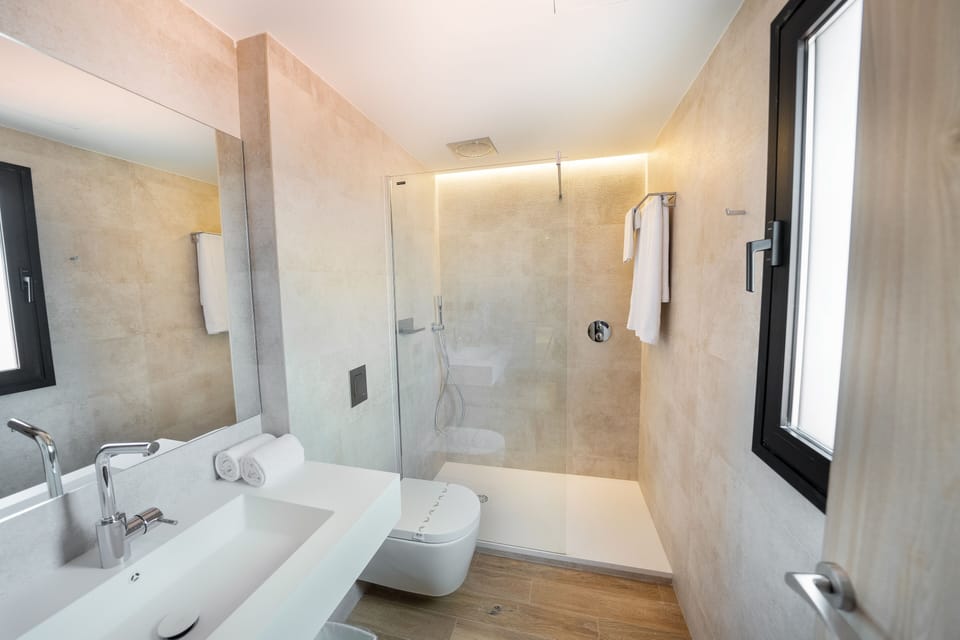 Shower, rainfall showerhead, hair dryer, towels