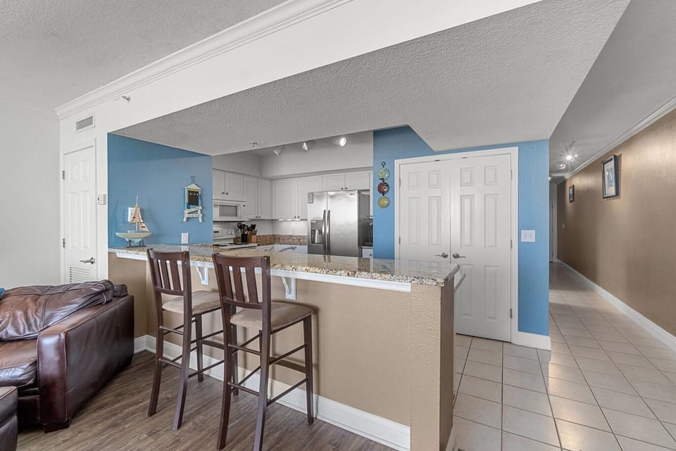 Kitchen w/ granite, s/s appliances, is well stocked & has bar with seating for 2