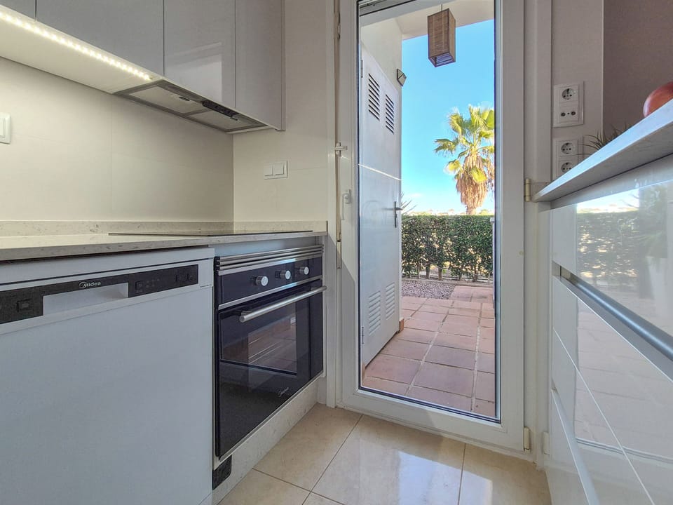 Kitchen. The washing machine is outside the kitchen door.