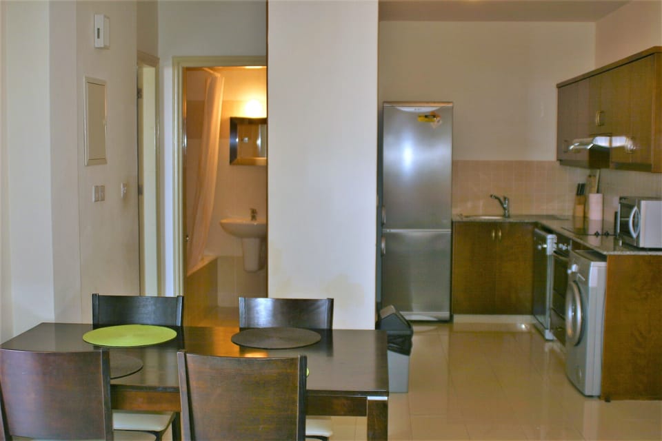 View of the dining table, kitchen and the bathroom from the lounge