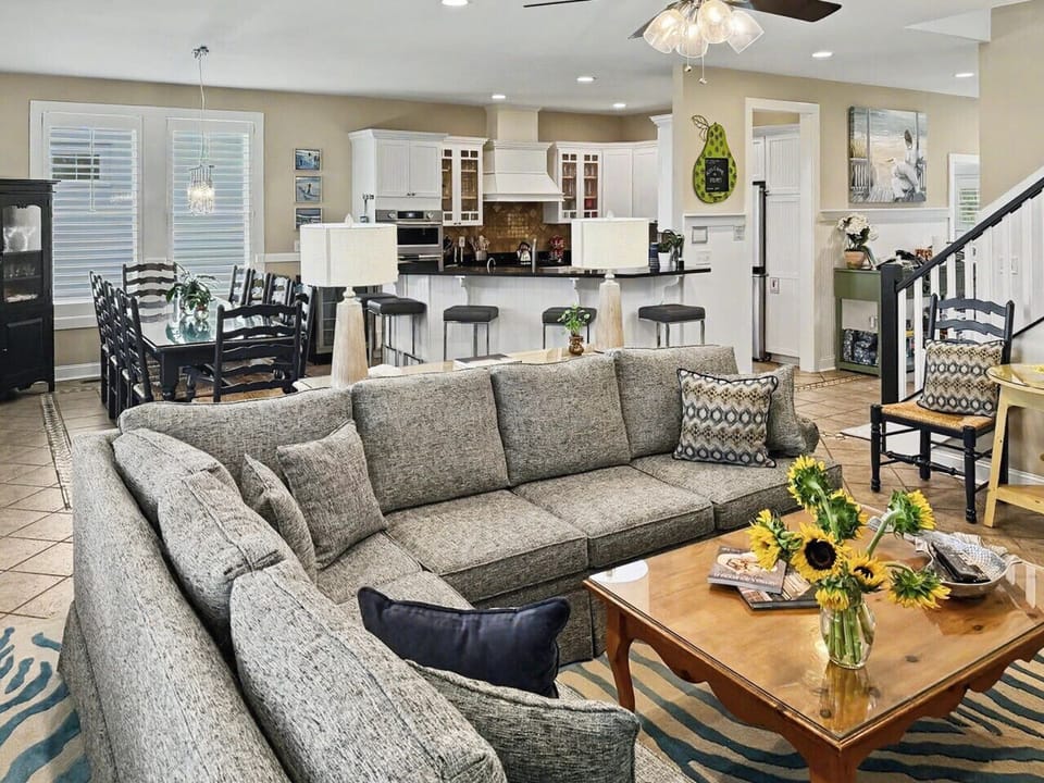 Designed for multi-generational vacations, this bright coastal space features oversized seating, a gourmet kitchen, a large family dining area, and plenty of room for everyone.