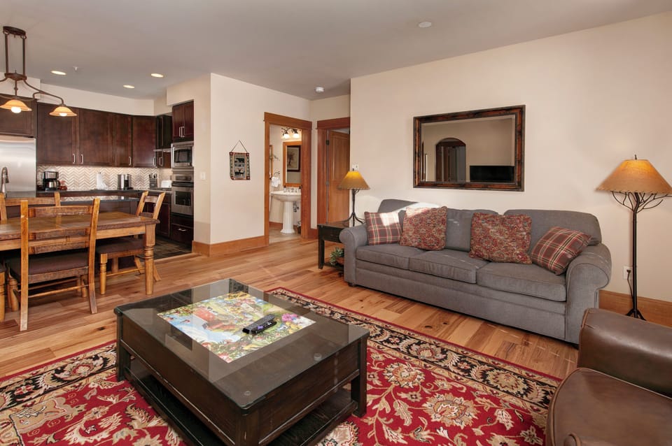 Living Room with moss rock fireplace, HDTV and queen sofa bed.