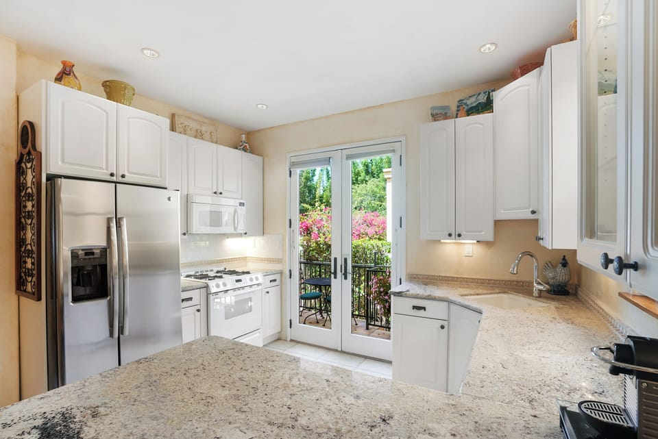 Thoughtfully designed kitchen featuring a private washer and dryer.