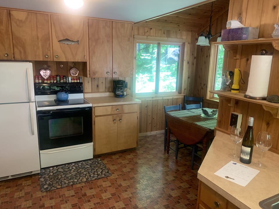 Kitchen with new fridge and eat-in nook.