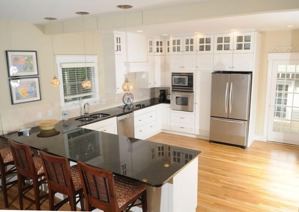 Gourmet kitchen with top-of-the-line appliances, granite countertops.