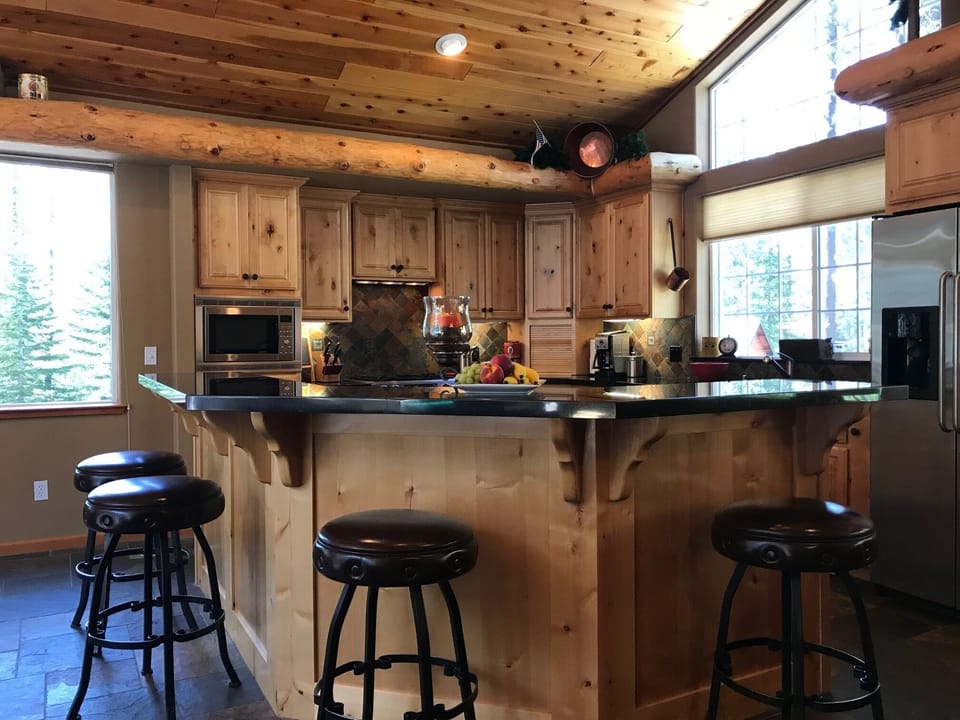 Large kitchen open to family room with stainless appliances