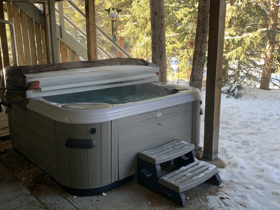 Enjoy a relaxing soak in the hot tub overlooking the Blue River.