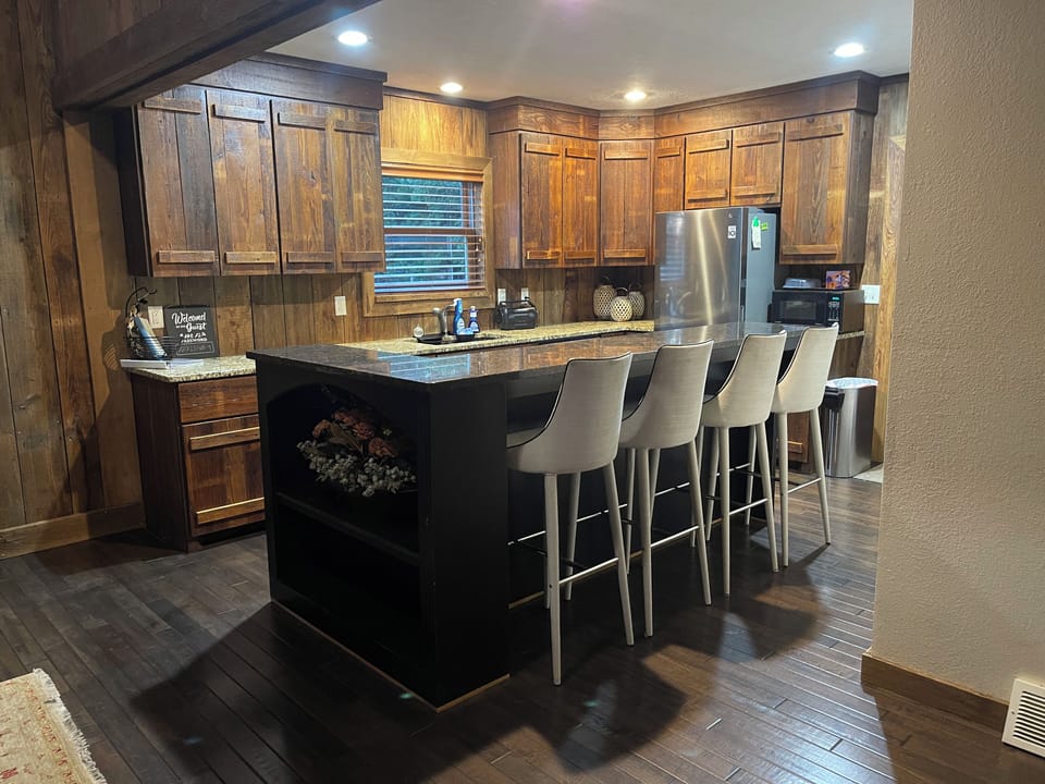 Kitchen with island, induction cooktop, DW, Microwave, Stove, Refrigerator. 