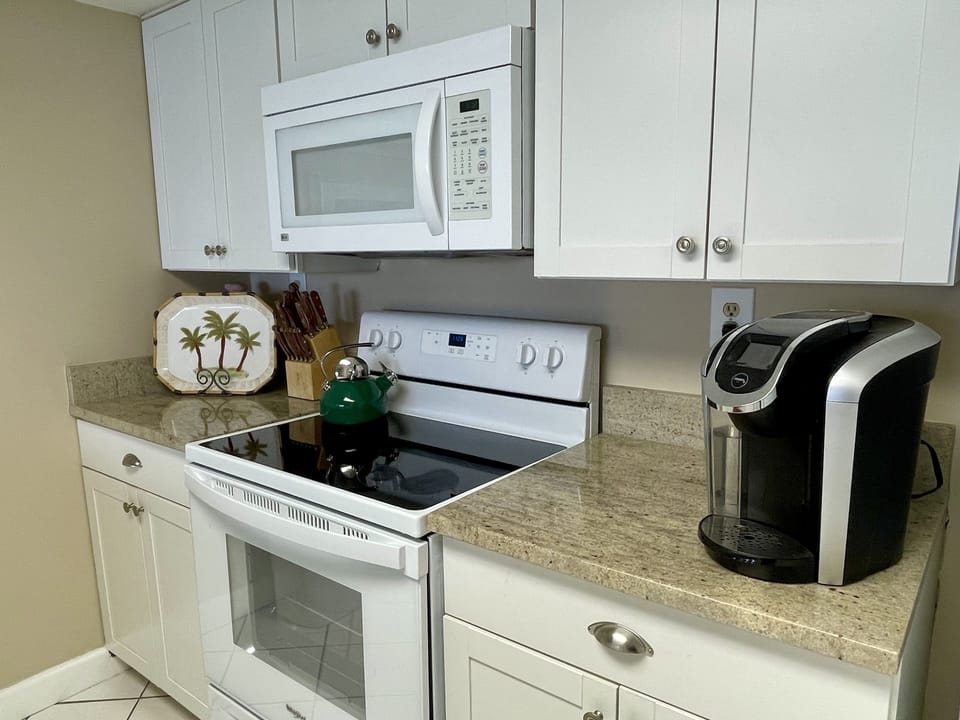 Condo has a fully-stocked kitchen; granite counters, new range, fridge/ice maker