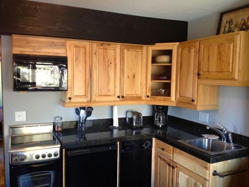 Beautiful kitchen with granite, refrigerator, dishwasher, microwave