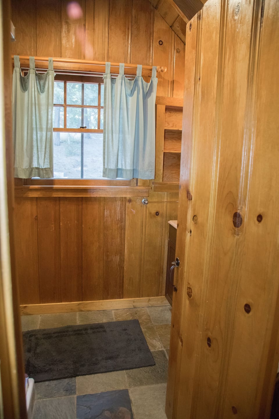 Upstairs shared full bath at top of stairs; shower to the left