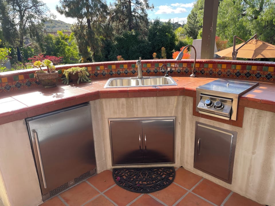 Outdoor beverage cooler, sink and gas cook top