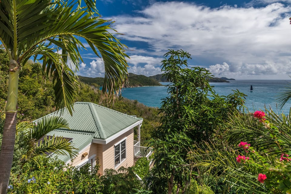 Overlooking Hurricane Hole and surrounded by beautiful gardens.
