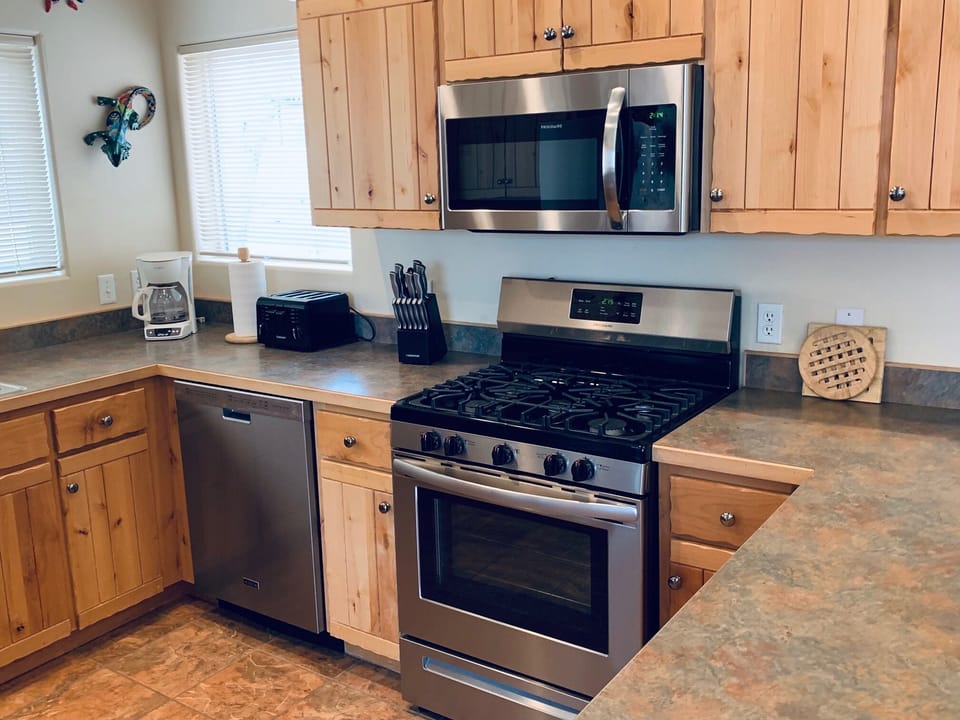 Dishwasher, microwave, gas range, and refrigerator, & spice rack 