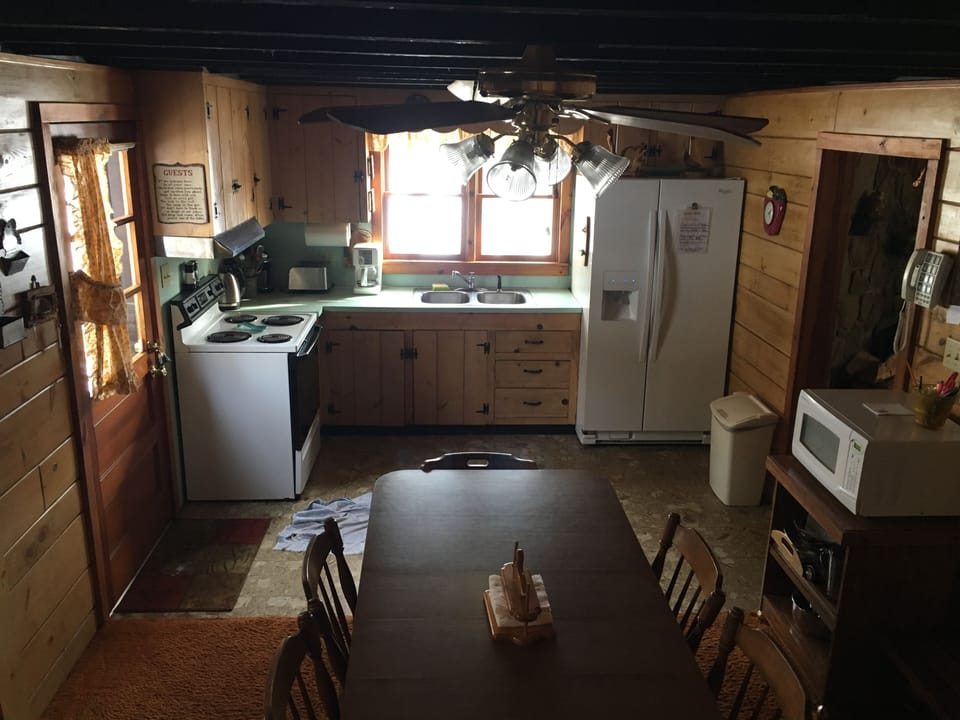 Kitchen and dining area with seating for 9. 
