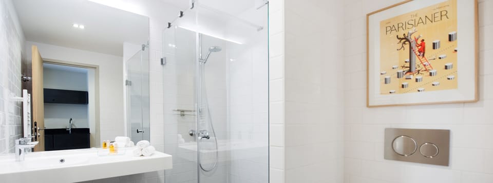 Designer toiletries, hair dryer, slippers, towels